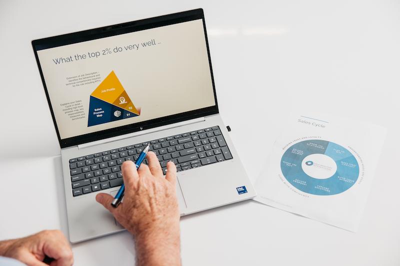 A laptop with a sales accountability system on the screen.